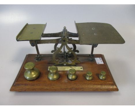 A Victorian Aneroid barometer, a modern barometer and a set of postal scales with weights  