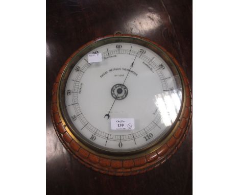 A Victorian oak circular aneroid barometer, a smaller aneroid barometer and a thermometer (3)  