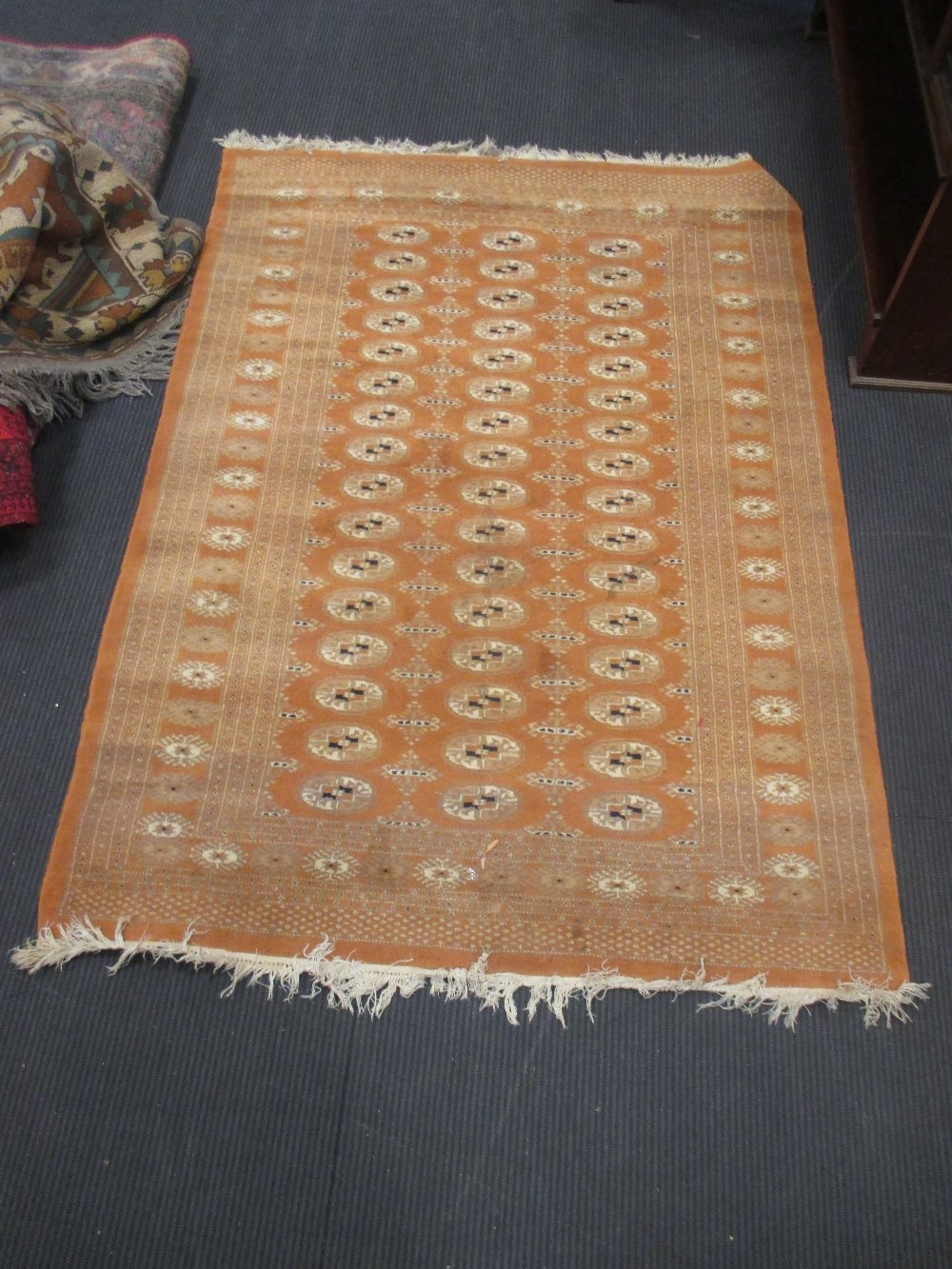 A faded Bokhara rug, a floral pattern Persian rug and four small