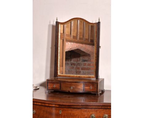 A George III mahogany dressing mirror, circa 1780, with boxwood stringing throughout, the rectangular swing plate supported b