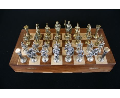 CHESS - a wooden chess board with sets of chess pieces x2, a traditional wooden set and a Roman Army set in brass and nickel 