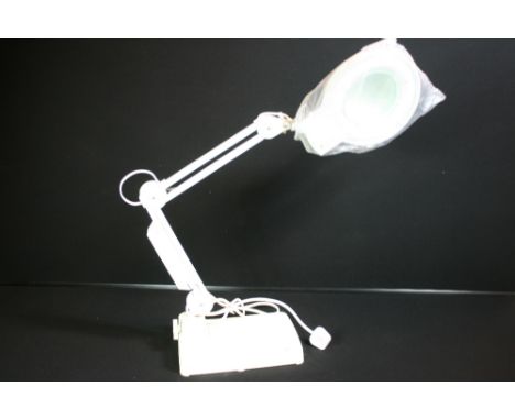 MAGNIFYING ANGLEPOISE DESK LAMP - A magnifying desk lamp in white.