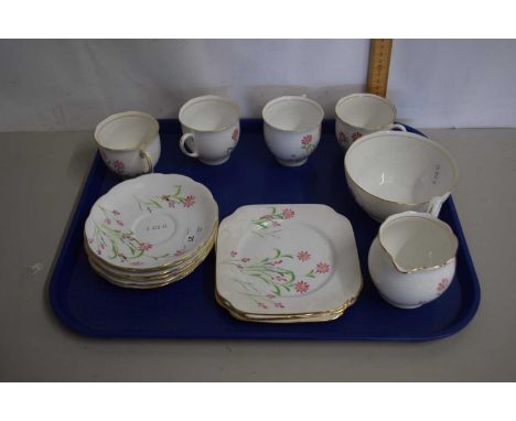 An English porcelain tea service comprising cups, saucers, side plates and tray