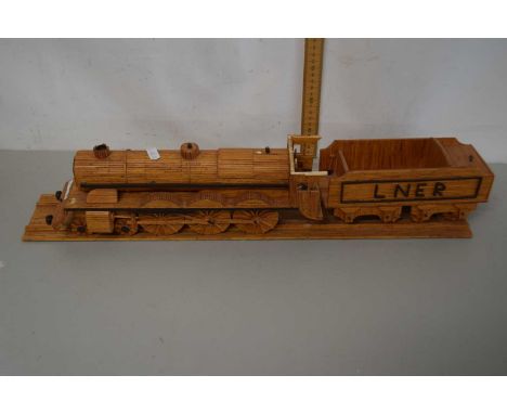 A wooden model of a steam engine with tender, the tender marked LNER