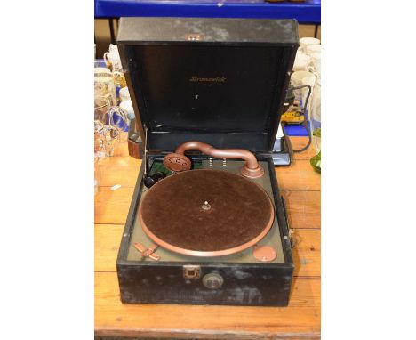A vintage gramophone player in original case together with a vintage telephone marked AP12932