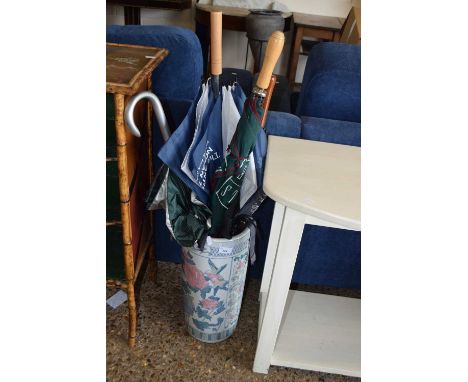 An Oriental style umbrella or stick stand with decoration of birds together with a quantity of various umbrellas