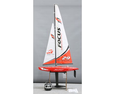A JOYSWAY FOCUS 2.4GHZ RTR RACING YACHT, Model No:9902, the fibreglass model with transmitter and operating manual, on displa
