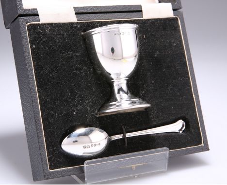 A GEORGE V SILVER EGG CUP AND SPOON,&nbsp;by&nbsp;Pinder Brothers, Sheffield 1935, cased. 6.2cm high,&nbsp;1.6 troy ouncesThe