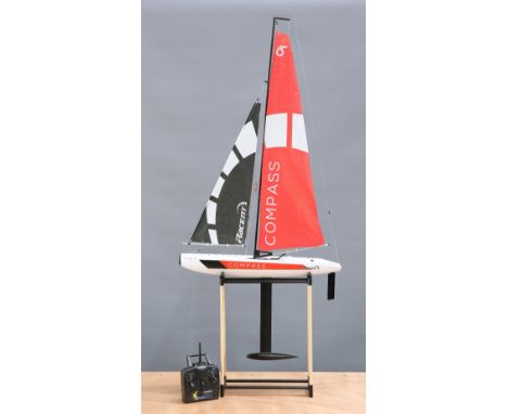 A VOLANTEX COMPASS 2.4GHZ RTR YACHT, V791-1, the 650mm fibreglass sailing model with transmitter, on display stand. Yacht hei