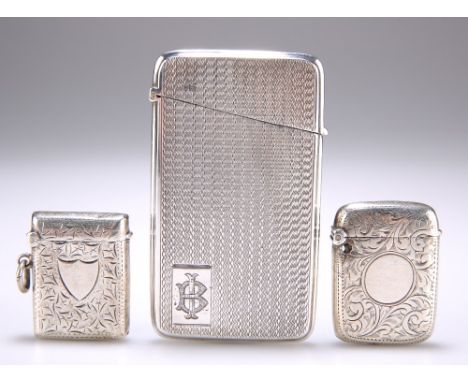 A GEORGE V ENGINE TURNED SILVER CARD CASE, Chester 1924; AND TWO SILVER VESTA CASES.&nbsp;2.78 troy ounces gross (3)