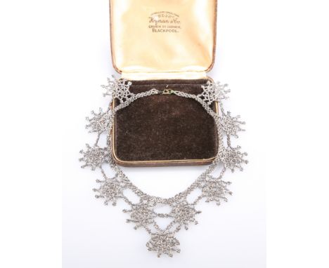 A 19TH CENTURY CUT STEEL NECKLACE, faceted steel beads as star motifs. Drop length 6cm, necklace length 38cm&nbsp;The absence