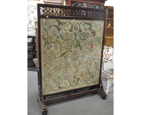 A late 19th century mahogany firescreen with Edwardian silkwork inset  