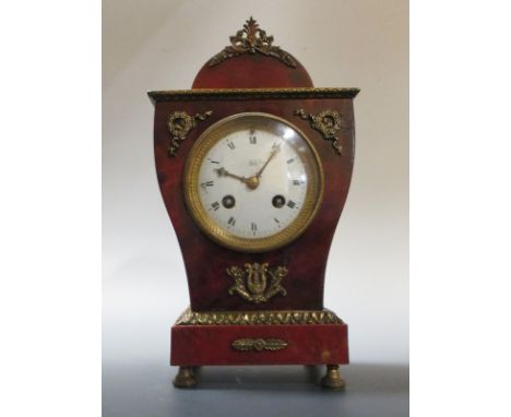 A late 19th century red tortoiseshell and ormolu mantle clock  