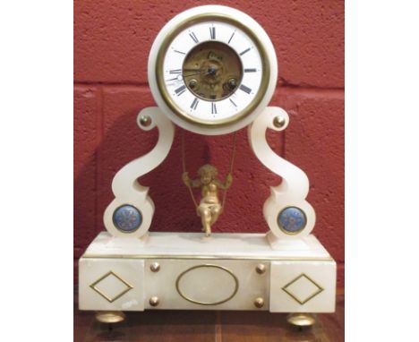 An alabaster mantle clock with swinging cherub pendulum  