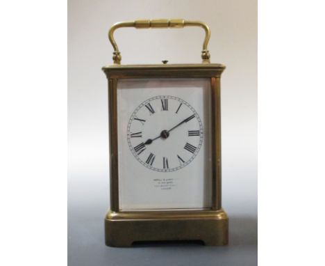 A brass repeating carriage clock, enamel dial, gong strike, by Richard & Cie  