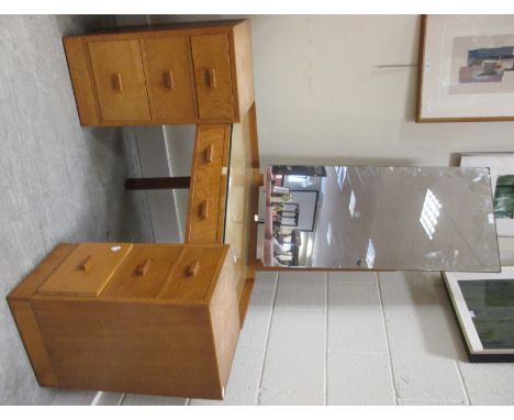 A 1950s light oak corner dressing table, topether with a matching chest of drawers  