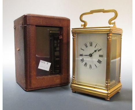 An oval brass carriage clock, and another with leather travel case  