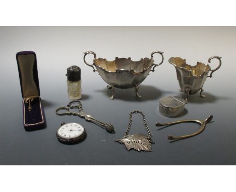 A matching silver cream jug and sugar bowl by HM, Brimingham 1895, with facetted tapering bod and flying scroll handles; a sm