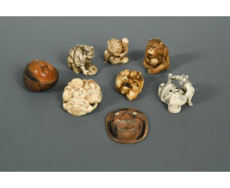 A collection of 8 netsuke, Meiji period and later, two in wood and five in ivory, (three of them signed), including a manju-n