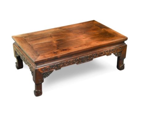 A Chinese carved hardwood opium table, with carved and pierced frieze and on scroll carved feet 30 x 82 x 50cm (12 x 32 x 20i
