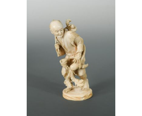 An ivory okinomo, the figure carrying a large parsnip, Meiji period, the male figure walking barefoot, his head looking to hi