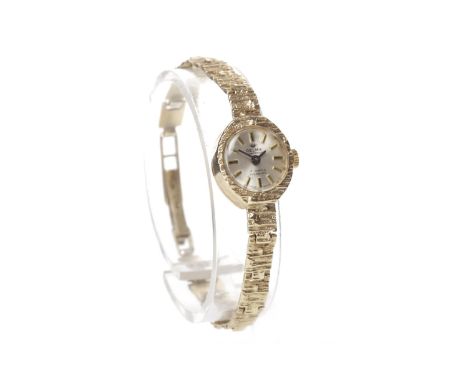 LADY'S DELMA OF SWITZERLAND NINE CARAT GOLD MANUAL WIND WRIST WATCH the round silvered dial with applied gold baton hour mark