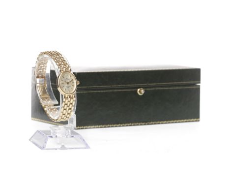 LADY'S SOVEREIGN NINE CARAT GOLD QUARTZ WATCH the oval cream dial with applied baton hour markers with a gem set 12 hour mark