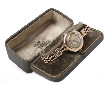 LADY'S NINE CARAT GOLD MANUAL WIND WRIST WATCH the round gold coloured dial with Roman numerals, outer seconds track in gold,