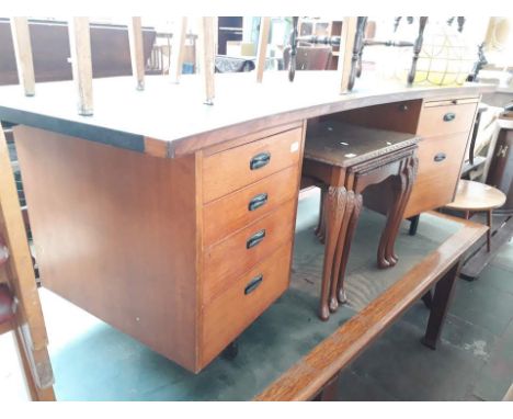 A vintage teak desk with tooled leather top 