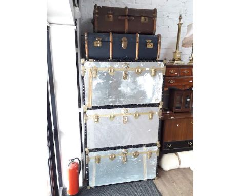 A stack of 5 vintage travel trunks 