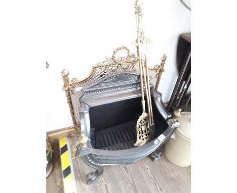 A cast metal fire grate, ornate brass fire screen and utensils 