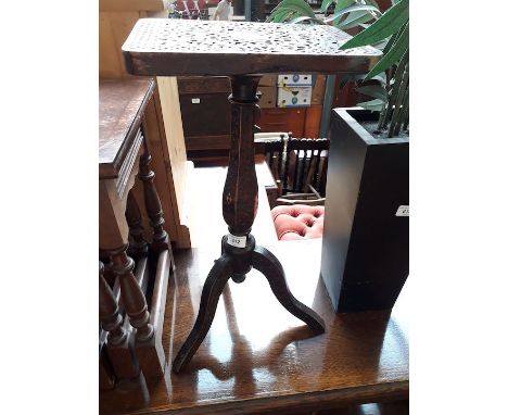 A carved tripod table 