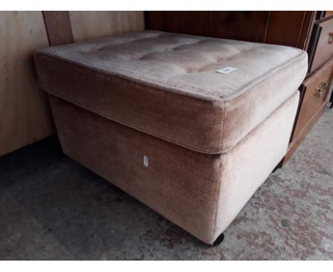 An upholstered pouffe 