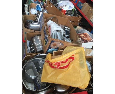 A table top of kitchen utensils, cooking pans, Pyrex, pressure cooker, stainless steel items, aluminium products, pottery, et