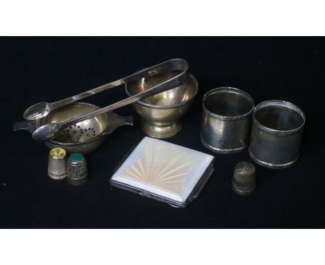 A small group of silver including Art Deco silver and enamel cigarette case, tea strainer and napkin rings.