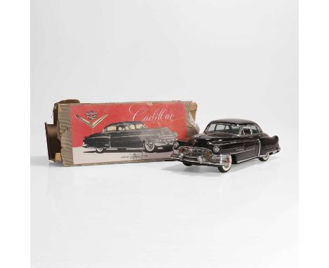 A Marusan Cadillac toy car, c.1950, a black tinplate friction-driven Cadillac made by Marusan, Japan, with original box as is