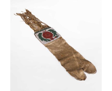A Native American beaded hide pipe bag, 19th century, the floral top below tassels,77cm long overallProvenance: Formerly from