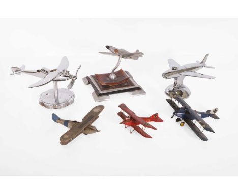 Seven model aeroplanes, mid-20th century, comprising four wooden examples and three chromed mascots,largest 15.5cm long (7)