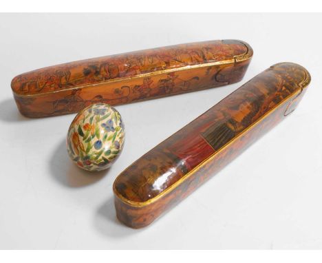 Two papier mâché pen boxes or 'qalamdans', 19th century, from Qajar, Iran, one example decorated with a battle scene, the oth