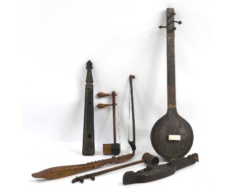 A collection of Southeast Asian musical instruments, comprising two erxians, one example with a bow, a similar stringed instr