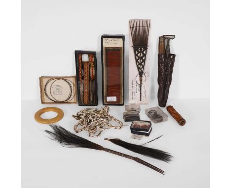 A collection of African items, 20th century, to include cowrie shells, a Bakelite bangle, fibre armbands and similar items (q