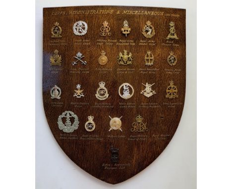 23 Corps &amp; Services cap badges mounted on shield.   Good selection beautifully mounted on varnished wooden shield, each w