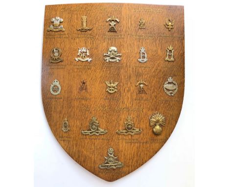 19 Cavalry &amp; Artillery cap badges mounted on shield.   Good selection beautifully mounted on varnished wooden shield, eac