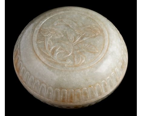 A Chinese Mugal-style jade box and cover: carved with a floral spray and two fluted bands, the stone of russet and cream flec