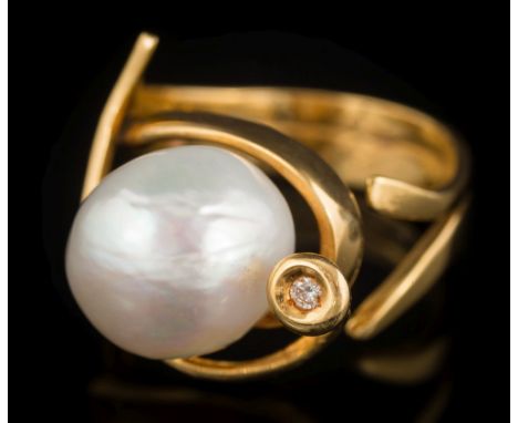 A Portuguese freshwater cultured pearl and diamond set ring: the baroque cultured pearl approximately 12mm diameter in a scro