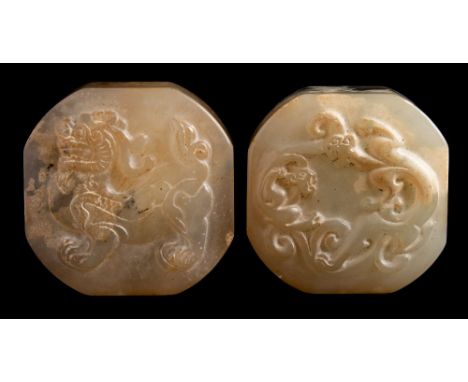 Two Chinese jade seals: of rounded octagonal form, one carved with chilong, the other with a buddhistic lion dog, both with f