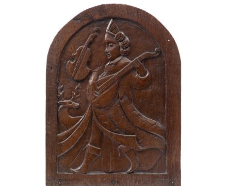 A carved oak domed panel: depicting  Orpheus playing a lute, carved in low relief, 46.5cm x 34cm.