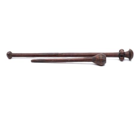 An  African knobkerrie: of traditional design with bulbous head and tapering shaft, 48cm. long, together with another club, 3