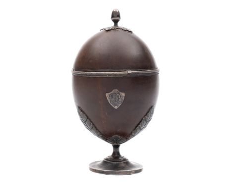 An early 19th century silver mounted coconut cup: inscribed,  the domed lift-off  lid with acorn finial, the base with applie