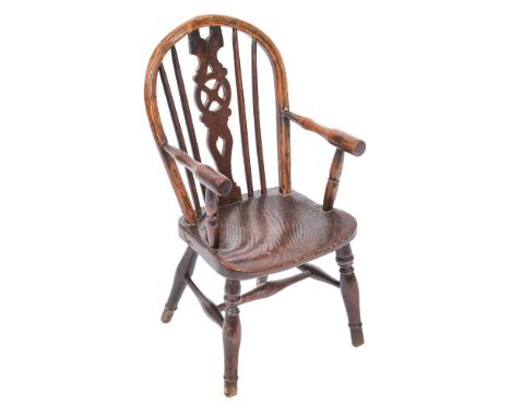 A child's early 19th Century elm and beechwood wheel and stick back Windsor elbow chair:, with a shaped and pierced central s